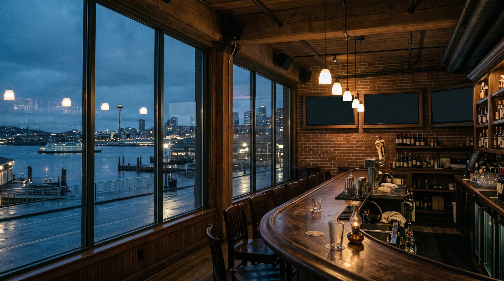 Seattle waterfront bar at dusk with wall displays and ceiling speakers