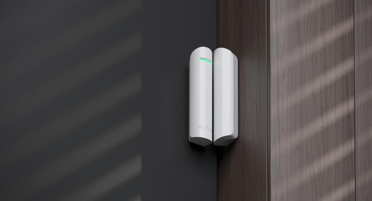 Ajax DoorProtect sensor on a white door