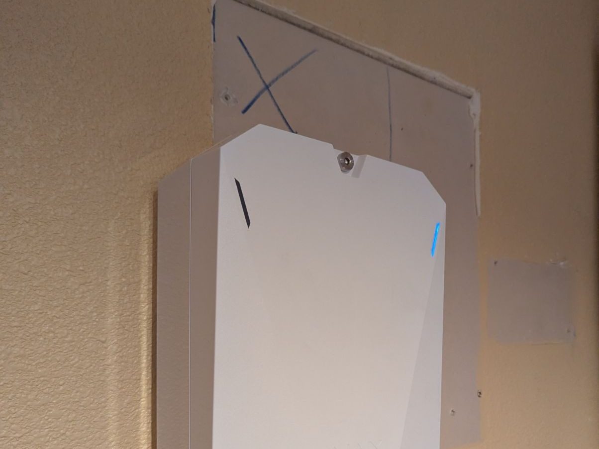 An Ajax MultiTransmitter enclosure mounted on the wall where the old alarm panel had been